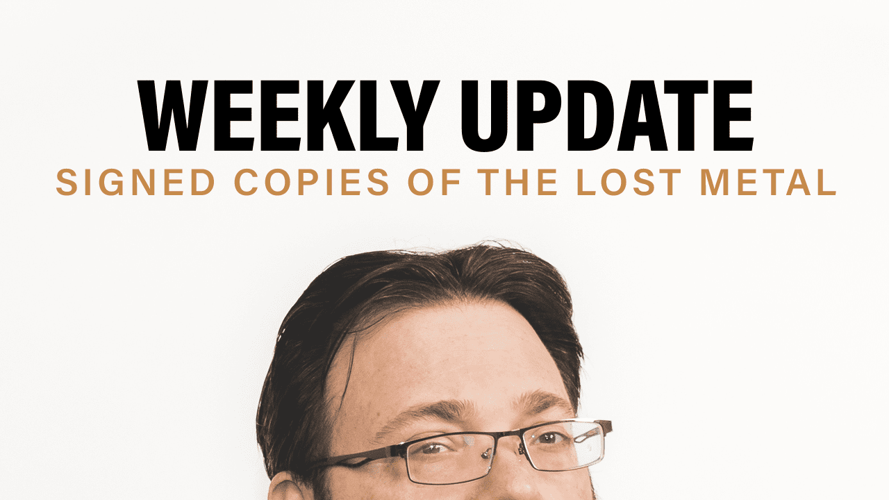 Photo of half of Brandon's face peaking over the screen. Text saying Weekly Update: Signed copies of the Lost Metal